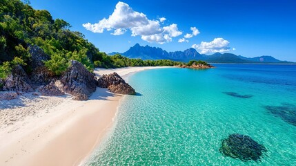 Fototapeta premium Idyllic tropical beach with turquoise water, white sand, and mountains.