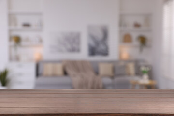 Empty wooden table in beautiful living room. Space for design