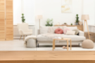 Empty wooden table in beautiful living room. Space for design