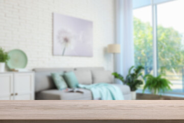 Empty wooden table in beautiful living room. Space for design