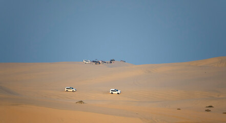 Off-road vehicles and scenery on a desert safari tour in Doha, Qatar