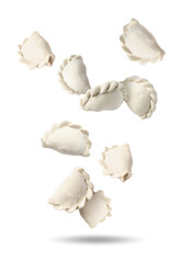 Raw dumplings (varenyky) in air on white background