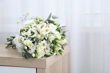 Beautiful wedding bouquet on wooden nightstand indoors, space for text