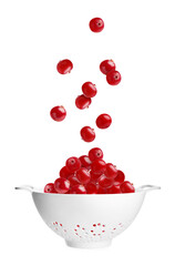 Fresh berries falling into colander on white background