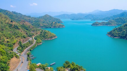 Obraz premium Scenic Aerial View of Serene Blue Lake Surrounded by Lush Green Mountains