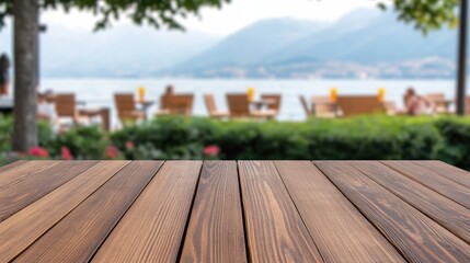 Fototapeta premium Scenic View of Wooden Table Overlooking Lake and Mountains in Background