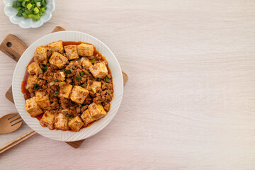 Mapo tofu. Stir-fried tofu with hot spicy sauce in white plate.