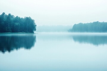 A serene misty lake surrounded by trees, reflecting a tranquil atmosphere.