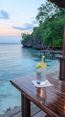 Tropical beach sunset cocktail drink ocean view resort.