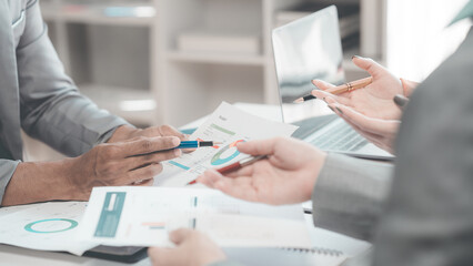 Close-up of Business Colleagues team analyzing financial data at table in modern office on business...