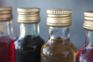 Vibrantly Colorful Bottles of Syrups Featuring Elegant Golden Caps
