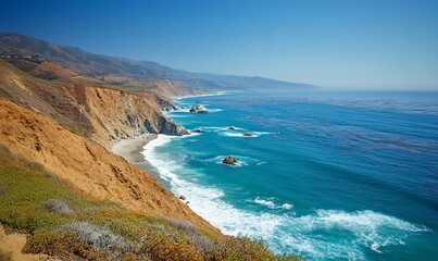 Scenic coastal view with cliffs, ocean waves, and clear blue sky.