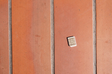 a phone sim card dropped on a tiles floor. lost sim card concept