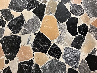 Detailed view of terrazzo stone surface showcasing a mix of black, beige, and white stone fragments