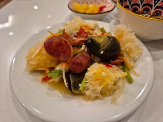 Traditional spicy mixed salad in Thai restaurant. Famous local diet food menu in Asia. Fresh vegetable and herbal spices dressing with special sauce.