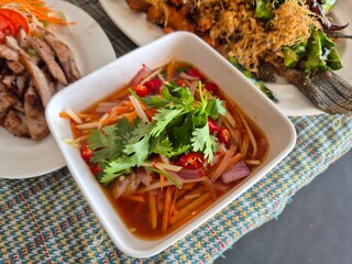 Spicy and chilly Thai local dipping sauce serving on the bowl. Famous sliced carrot, shallot,...