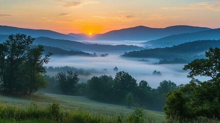 Beautiful Sunrise Over Misty Morning Mountains with Gentle Fog