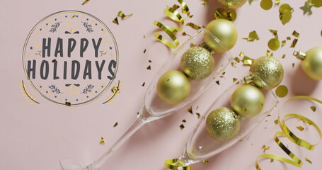 Image of happy new year text over confetti and champagne glasses with baubles