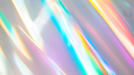 Obraz premium Blurred rainbow light refraction texture overlay effect for photo and mockups. Organic drop diagonal holographic flare on a white wall. Shadows for natural light effects