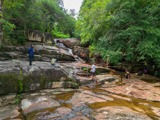 Aerial drone view of an amazing waterfall with unique rocks formations at Batu Ferringhi, Penang Island, Malaysia.