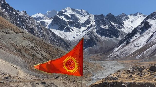 Om flag fluttering near Om Parvat is a sacred peak in the Himalayas whose snow deposition pattern resembles the sacred 'Om'. Situated in Uttarakhand, India