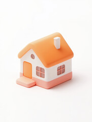 A charming miniature house model with an orange roof and pastel colors, symbolizing warmth and home.