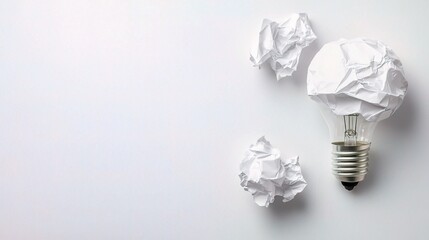 Crumpled White Paper Textures with Light Bulb on a Clean Surface
