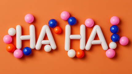 Let's Laugh Day concept. Colorful beads and letters form playful phrase HA HA on orange background