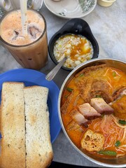 Malaysian Singaporean breakfast of curry mee, laksa, kaya toast and teh tarik