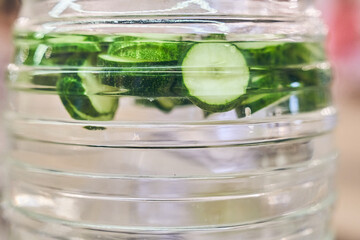 Refreshing cucumber cocktail in close-up in a transparent bottle. Transparent background with space to copy. High quality photo