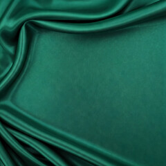 Dark green silk satin background. Beautiful soft folds on the smooth surface of the fabric. Luxury background with copy space for design. abstract background design.