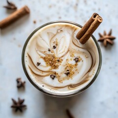 Delicious iced chai latte in a glass. Featuring spices sprinkled on top