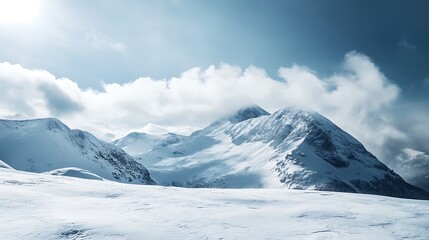 Snowy mountain peaks under a cloudy sky. Majestic winter landscape.