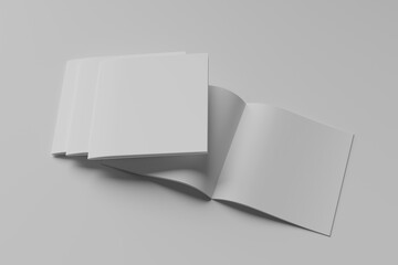 stack of three Open and closed blank brochures on grey background