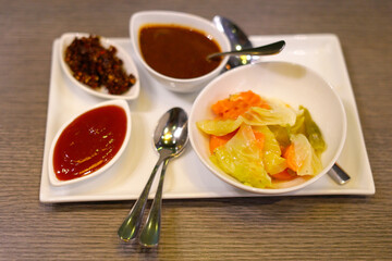 tomato sauce, vegetable chopsuey, chili paste dish image on the table