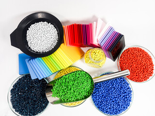 Colorful masterbatch plastic granules with color chips, colorful polymer pigment granules isolated on white background, for product catalog design of plastic manufacturing industry company profile