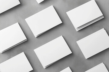 Closeup of empty white rectangle business card mockups lying diagonally on neutral grey concrete background. Flat lay, top view. Open composition. Blank Template for Corporate Identity