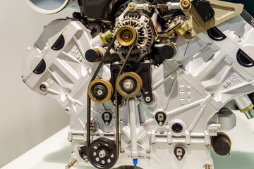 Naklejka premium Munich, Germany, 16.07.2024 - A detailed close-up of a car engine showcasing its intricate belts and pulleys, illustrating how they work together to transfer power efficiently and effectively.