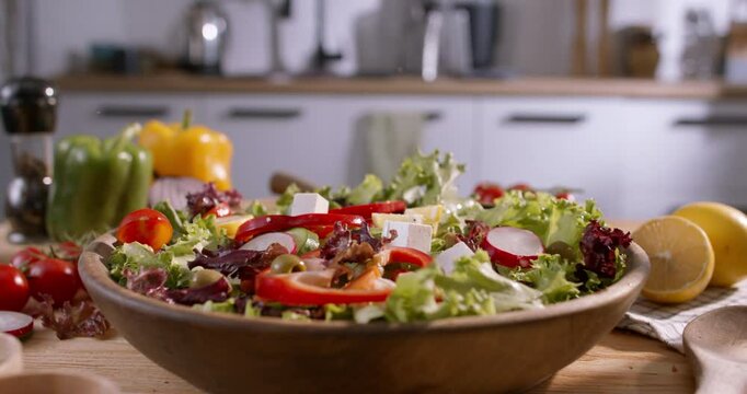 Appetizing Close-Up of Fresh Ingredients Falling into a Mediterranean Salad, Emphasizing Healthy Lifestyle and Wholesome Home Cooking
