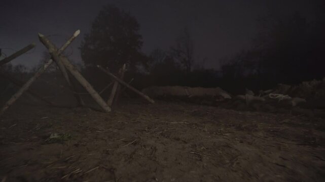 World war one soldier runs through dark trenches, navigating the dangers of battle during a tense night in the conflict