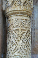 A historical building framed with artistically carved stonework. Architectural detail from the Divriği Great Mosque and Hospital, listed on the UNESCO World Heritage List. Floral and geometric motifs.