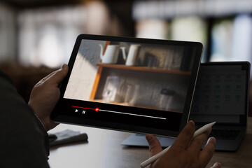Man watching online videos on Tablet Movie streaming app  at home