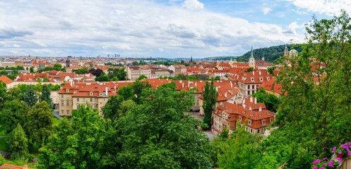 A stunning panoramic view of the red roofs of Prague, Czech Republic, showcasing the city s historic architecture, charming streets, and the iconic Prague Castle in the background.