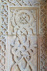 A historical building framed with artistically carved stonework. Architectural detail from the Divriği Great Mosque and Hospital, listed on the UNESCO World Heritage List. Floral and geometric motifs.