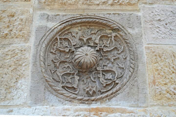 A historical building framed with artistically carved stonework. Architectural detail from the Divriği Great Mosque and Hospital, listed on the UNESCO World Heritage List. Floral and geometric motifs.