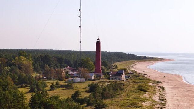 Aerial panoramic landscape of Lighthouse building of Akmenraga, Latvian beach, coastline, Baltic sea and forested area