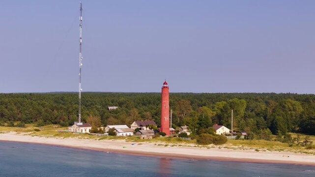 Aerial panoramic landscape of Lighthouse of Akmenraga Latvia, forested beach coastline