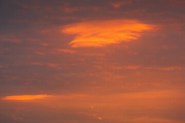Obraz premium Spectacular British Dawn Sky with Burning Orange Cloud Formation. Natural abstract sunrise background captured in the UK with glowing tangerine clouds and atmospheric drama