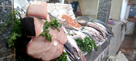 Fresh fish and seafood displayed on a market stall, offering a variety of choices