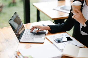 Portrait of a woman working on a tablet computer in a modern office. Make an account analysis report. real estate investment information financial and tax system concepts